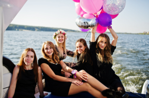 Birthday yacht rental Miami celebration with Yacht Scarlet Charters featuring friends enjoying luxury yacht party balloons outdoors.